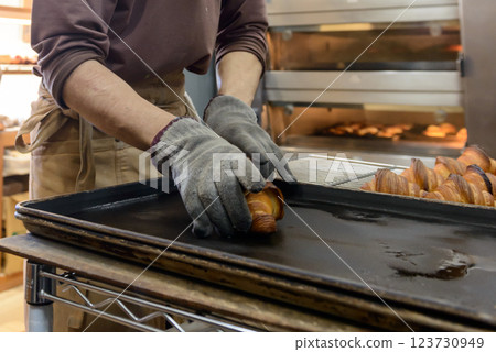 Freshly baked croissants, baker Freshly baked croissants, baker 123730949