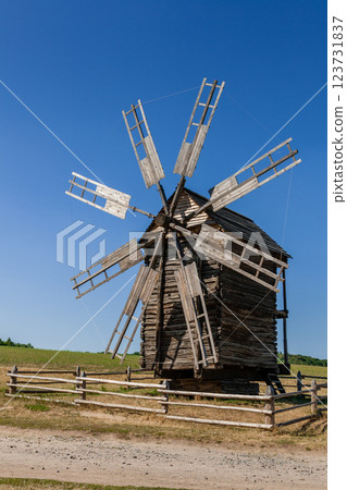 Old windmill on blue sky background Old windmill on blue sky background 123731837