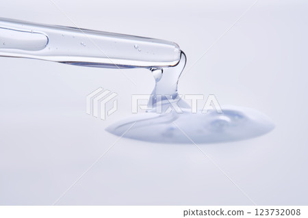 Pipette with delicate blue serum close-up. 123732008