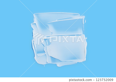 A smear of white cream in the shape of a square on a blue background. 123732009