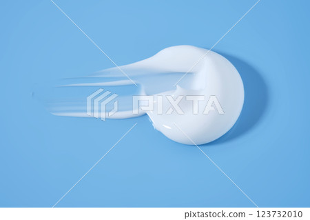 A smear of white cream on a blue background. 123732010