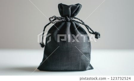 A black bag with a black string tied around it 123732524