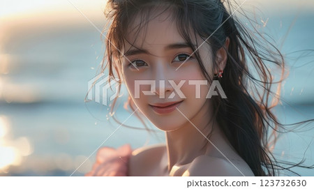 A woman with long hair and a pink dress is smiling at the camera 123732630