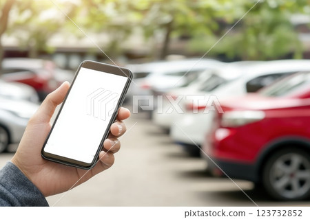 Hand Holding Smartphone with Blank Screen in Outdoor Parking Lot 123732852