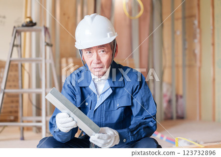 A male craftsman inspecting light steel beams at a construction site A male craftsman inspecting light steel beams at a construction site 123732896