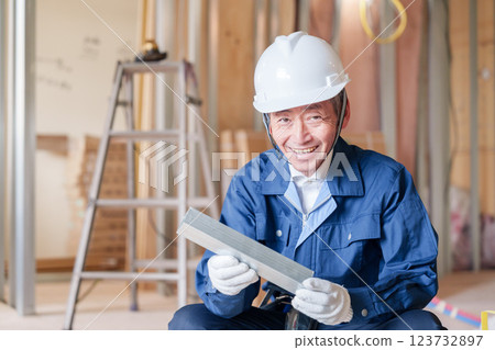 A male craftsman inspecting light steel beams at a construction site A male craftsman inspecting light steel beams at a construction site 123732897