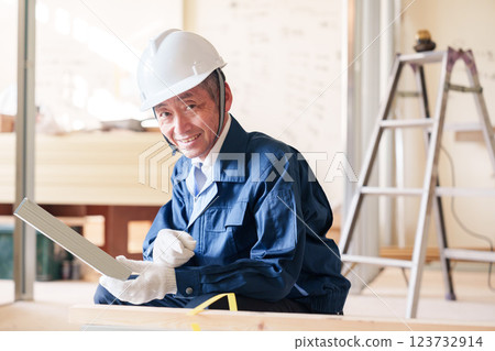 A male craftsman inspecting light steel beams at a construction site A male craftsman inspecting light steel beams at a construction site 123732914