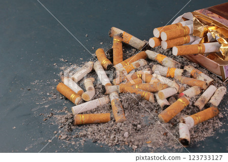 image of several commercial cigarettes with cigarette packs. pile of cigarettes on turquoise floor or No smoking, tobacco campaign concept. image of several commercial cigarettes with cigarette packs. pile of cigarettes on turquoise floor or No smoking, tobacco campaign concept. 123733127