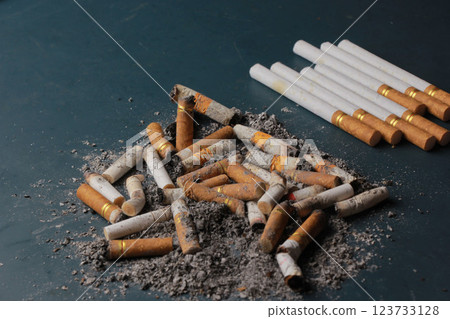Dirty cigarette butts with stack of cigarettes Dirty cigarette butts with stack of cigarettes 123733128