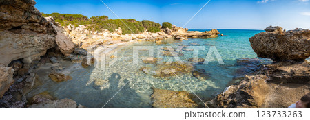 Coastline with a sandy beach and rocky shores near the northeasternmost cape of Northern Cyprus. Crystal-clear waters of a blue lagoon and the untouched beauty of the Mediterranean Coastline with a sandy beach and rocky shores near the northeasternmost cape of Northern Cyprus. Crystal-clear waters of a blue lagoon and the untouched beauty of the Mediterranean 123733263