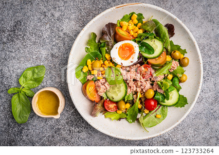 Tuna salad with tomatoes , olives , eggs and onion . 123733264