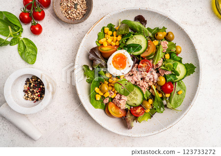 Tuna salad with tomatoes , olives , eggs and onion . Tuna salad with tomatoes , olives , eggs and onion . 123733272