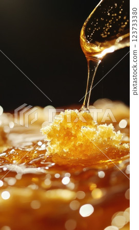 Spoon pouring rich honey over a freshly baked piece of bread for a sweet breakfast treat 123733380