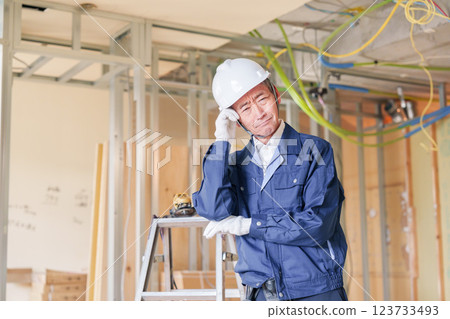 Male carpenter working at an apartment renovation site Male carpenter working at an apartment renovation site 123733493