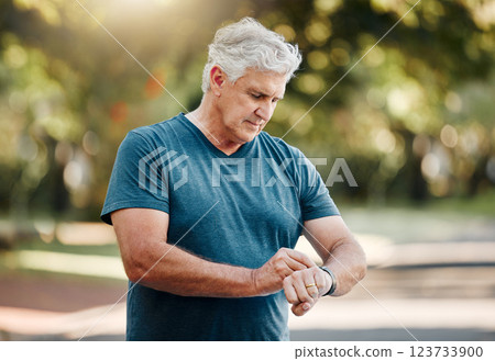 Watch, running senior man and nature fitness, park or outdoors road looking at time. Workout, sports and health exercise runner, marathon training and digital smartwatch sport tech app for run timer. Watch, running senior man and nature fitness, park or outdoors road looking at time. Workout, sports and health exercise runner, marathon training and digital smartwatch sport tech app for run timer. 123733900