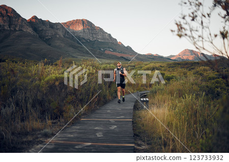 Health, man runner and in nature for training, wellness and fitness outdoor in the morning in sportswear. Exercise, male athlete, running on trail and workout warm up to be healthy and do cardio. Health, man runner and in nature for training, wellness and fitness outdoor in the morning in sportswear. Exercise, male athlete, running on trail and workout warm up to be healthy and do cardio. 123733932
