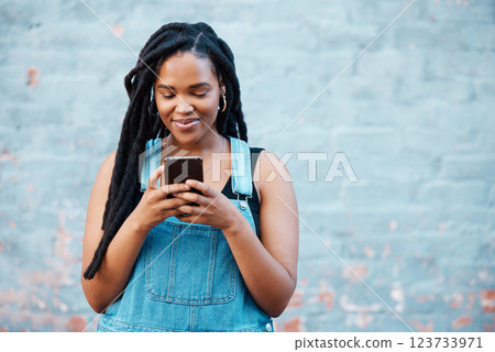 Happy black woman typing on smartphone on social media marketing, advertising or mobile app on blue wall background mockup. Gen z teenager with cellphone networking, online chat or check notification Happy black woman typing on smartphone on social media marketing, advertising or mobile app on blue wall background mockup. Gen z teenager with cellphone networking, online chat or check notification 123733971