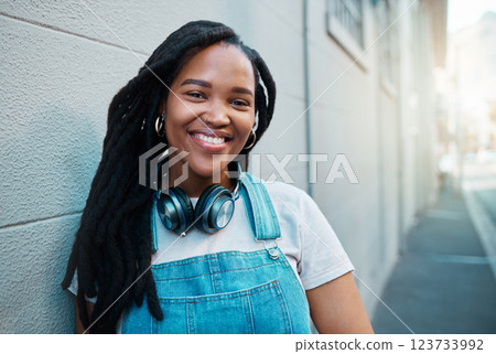 Black woman, smile and happy urban student girl on city street smiling and leaning against a wall outside on commute to college. Portrait of an African gen z female outdoors traveling in South Africa 123733992