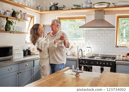 Dance, couple and kitchen with a senior man and woman dancing together in a retirement home. Love, freedom and romance with an elderly male and female pensioner having fun in a house in the morning 123734002