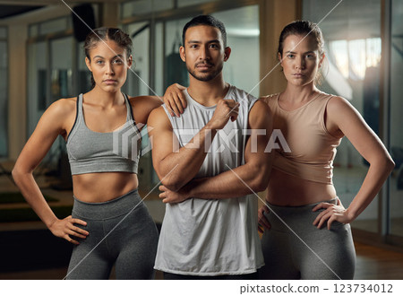 Fitness, people and portrait with personal trainer or group at gym for workout, physical training or confidence. Active, instructor or serious team with determination for exercise at health club 123734012