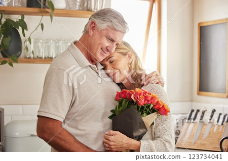 Flower bouquet, hug and senior couple in celebration of love, marriage and anniversary in their house. Happy elderly man and woman hugging with rose flowers for gift or present for birthday in home 123734041