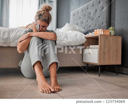 Crying, sad and depressed woman on bedroom floor using wipe for tears struggling with mental health, depression and anxiety after heartbreak or breakup. Upset or sick female cry about problem at home Crying, sad and depressed woman on bedroom floor using wipe for tears struggling with mental health, depression and anxiety after heartbreak or breakup. Upset or sick female cry about problem at home 123734069