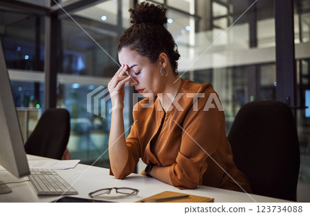 Woman working at night with headache, burnout and stress over social media marketing project or company deadline. Anxiety, exhausted and tired web or online business advertising expert with migraine 123734088
