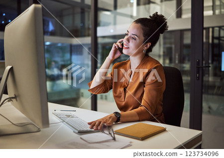 Phone call, communication and networking with a business woman working on a computer in her office late at night. Research, report and deadline with a female employee at her work desk for overtime Phone call, communication and networking with a business woman working on a computer in her office late at night. Research, report and deadline with a female employee at her work desk for overtime 123734096