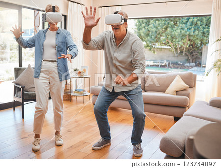 Retirement, vr and technology with couple and 3D gaming in the metaverse, internet or futuristic in living room. Virtual reality, creative and games with old man and woman at home with future headset Retirement, vr and technology with couple and 3D gaming in the metaverse, internet or futuristic in living room. Virtual reality, creative and games with old man and woman at home with future headset 123734097