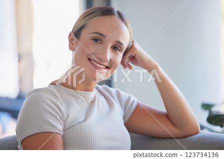 Face portrait of happy, smiling and content woman on sofa in living room in home, relax with smile on couch in lounge. Happy, smile and beauty female in house on the weekend enjoy leisure break 123734136