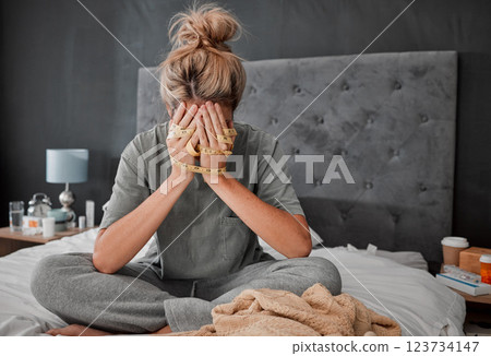 Hands, anorexia and depression with a woman on her bed holding a tape measure and looking sad or frustrated. Mental health, bulimia and eating disorder with a young female in her bedroom at home 123734147