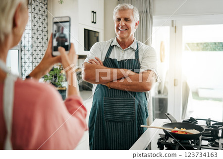 Senior man, phone and cooking photograph by woman for social media, live streaming or food vlog in Canada house kitchen. Smile, happy or confident home chef for about us website picture on technology 123734163