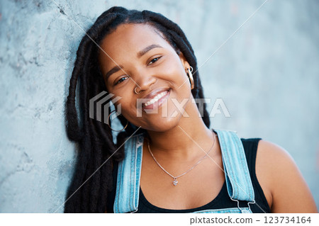 Black woman, face and freedom with a strong, independent or free female standing outdoor with a smile. Portrait of gen z with a millennial youth outside against a blue wall background 123734164