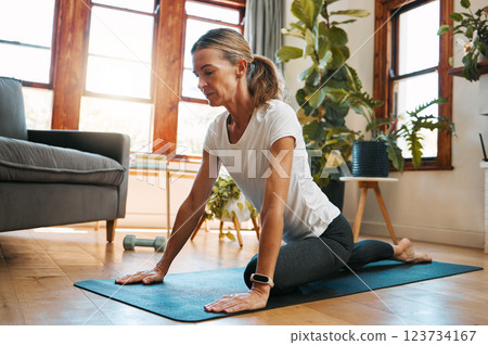 Woman, yoga and pigeon pose stretching in house or home living room for relax exercise, training and workout in Germany lockdown. Zen, calm and mature peace yogi in mind wellness and fitness for hips Woman, yoga and pigeon pose stretching in house or home living room for relax exercise, training and workout in Germany lockdown. Zen, calm and mature peace yogi in mind wellness and fitness for hips 123734167