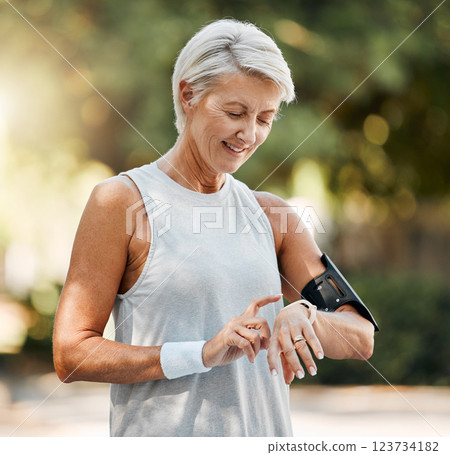 Senior woman, fitness and watch of running time in health and wellness for cardio exercise in nature. Active elderly female runner checking smartwatch to monitor training results in sports workout Senior woman, fitness and watch of running time in health and wellness for cardio exercise in nature. Active elderly female runner checking smartwatch to monitor training results in sports workout 123734182