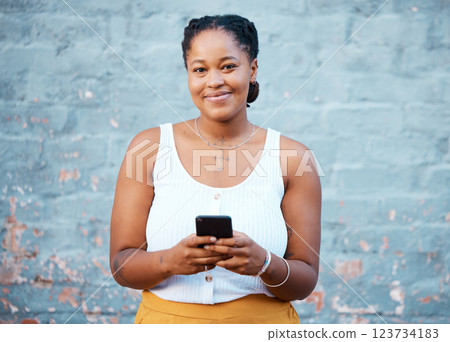 Black woman, portrait and phone for social media typing, contact and communication on smartphone technology on wall background in Nigeria. Happy gen z girl on mobile apps, 5g internet and web connect Black woman, portrait and phone for social media typing, contact and communication on smartphone technology on wall background in Nigeria. Happy gen z girl on mobile apps, 5g internet and web connect 123734183