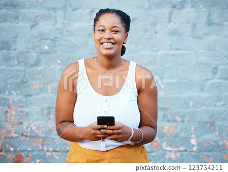 Smartphone, social media and black woman with 5g networking, internet connection or online search on blue wall mockup. Happy african girl with cellphone and portrait for website app marketing mock up 123734211