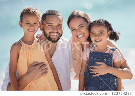 Family, happy at the beach and smile out in the sun while they enjoy and love to spend quality time together. Dad and mom hug kids, they bond and have fun on summer vacation in portrait. Family, happy at the beach and smile out in the sun while they enjoy and love to spend quality time together. Dad and mom hug kids, they bond and have fun on summer vacation in portrait. 123734285