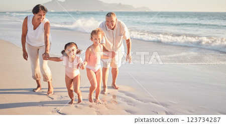 Family beach, summer love and children with smile for holiday at the sea in Mexico with grandparents. Portrait of girl kids running and playing by water on nature vacation with senior man and woman 123734287