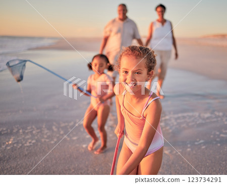 Children, fishing and family with a girl at the beach with her grandparents and sister for summer holiday. Kids, happy and ocean with a child on sand by the sea with her grandmother and grandfather 123734291