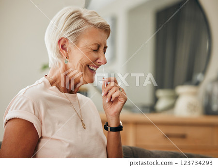 Covid, antigen rapid test and woman with nose swab for health, illness, or virus PCR results of senior with at home. Elderly lady, coronavirus and laughing using nasal stick for possible infection Covid, antigen rapid test and woman with nose swab for health, illness, or virus PCR results of senior with at home. Elderly lady, coronavirus and laughing using nasal stick for possible infection 123734293