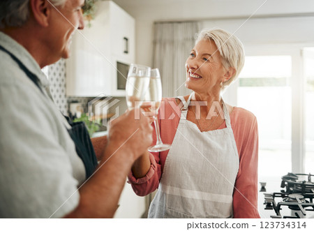 Senior couple, champagne and drinks toast in house or home kitchen in marriage anniversary, celebration event or retirement security success. Happy smile, love or elderly man, woman and alcohol glass 123734314