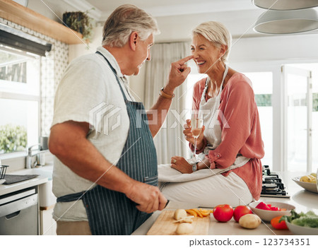 Champagne, cooking and senior couple in kitchen celebrate retirement with healthy food, vegetables or salad for vegan lifestyle. Celebrate, luxury and elderly woman celebrate with alcohol wine glass 123734351