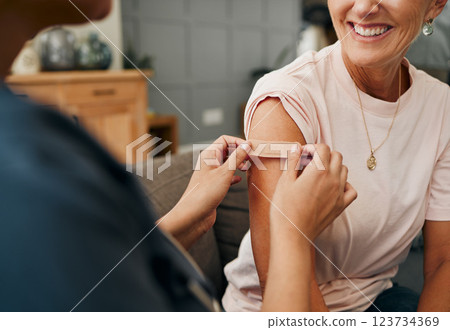 Woman, smile and plaster after injection for vaccine against covid. Happy, senior and lady vaccination for coronavirus on sofa in doctor office for health, wellness and safety from global pandemic Woman, smile and plaster after injection for vaccine against covid. Happy, senior and lady vaccination for coronavirus on sofa in doctor office for health, wellness and safety from global pandemic 123734369
