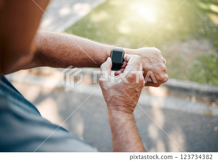 Man, street and running with smartwatch for heart reading, health and fitness on break. Runner, watch and road check time, speed or distance on workout, exercise or training outside for body wellness Man, street and running with smartwatch for heart reading, health and fitness on break. Runner, watch and road check time, speed or distance on workout, exercise or training outside for body wellness 123734382