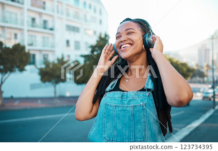 Music headphone city streaming, happy and black woman smile outdoor from Atlanta. Happiness of a person feeling relax freedom and cheerful mindset listening to audio and song track near the street 123734395