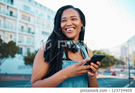 Student, street and happy girl with smartphone enjoying leisure break on weekend in Los Angeles. Black woman hipster with smile on commute with phone and headphones for music streaming in city. 123734409