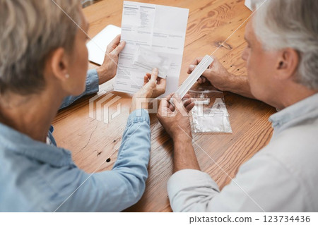 Old couple, documents and pcr covid test, health and testing for corona virus diagnosis at home. Covid 19, healthcare and senior, retired man and woman with medical kit for self screening in pandemic 123734436