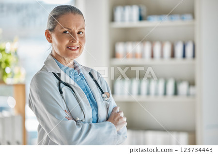 Medical portrait, healthcare doctor and woman with smile for working in medicine at a pharmacy. Happy, mature and expert pharmacist with arms crossed and pride while consulting in a hospital 123734443