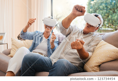 Elderly, couple and VR on sofa for gaming online in home living room. Man, woman and virtual reality glasses for esports while relax in house with technology, fun and 3D games together in retirement Elderly, couple and VR on sofa for gaming online in home living room. Man, woman and virtual reality glasses for esports while relax in house with technology, fun and 3D games together in retirement 123734454